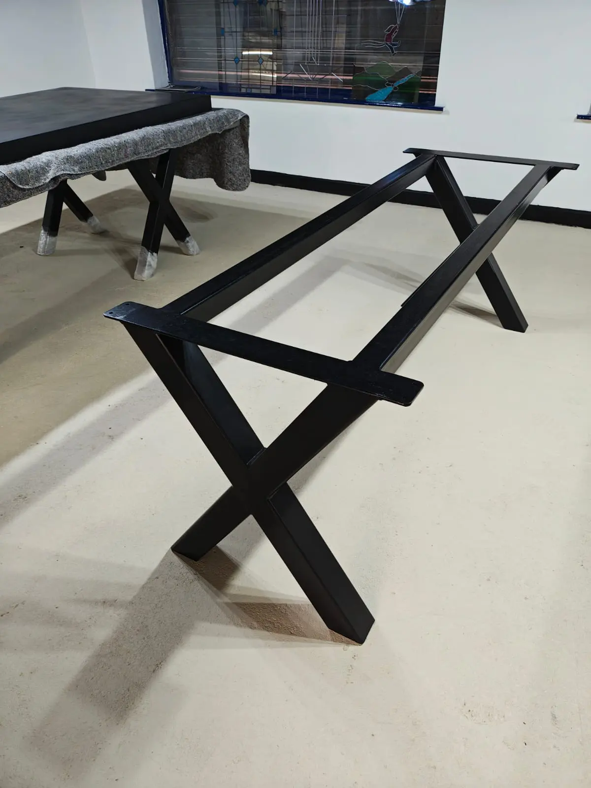 X frame steel table base with structural support
