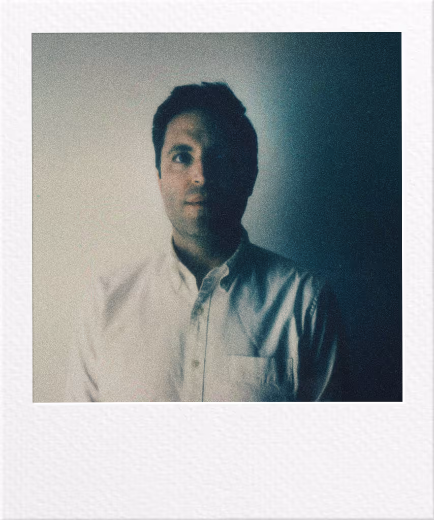Person in white shirt against moody blue-green polaroid-style background