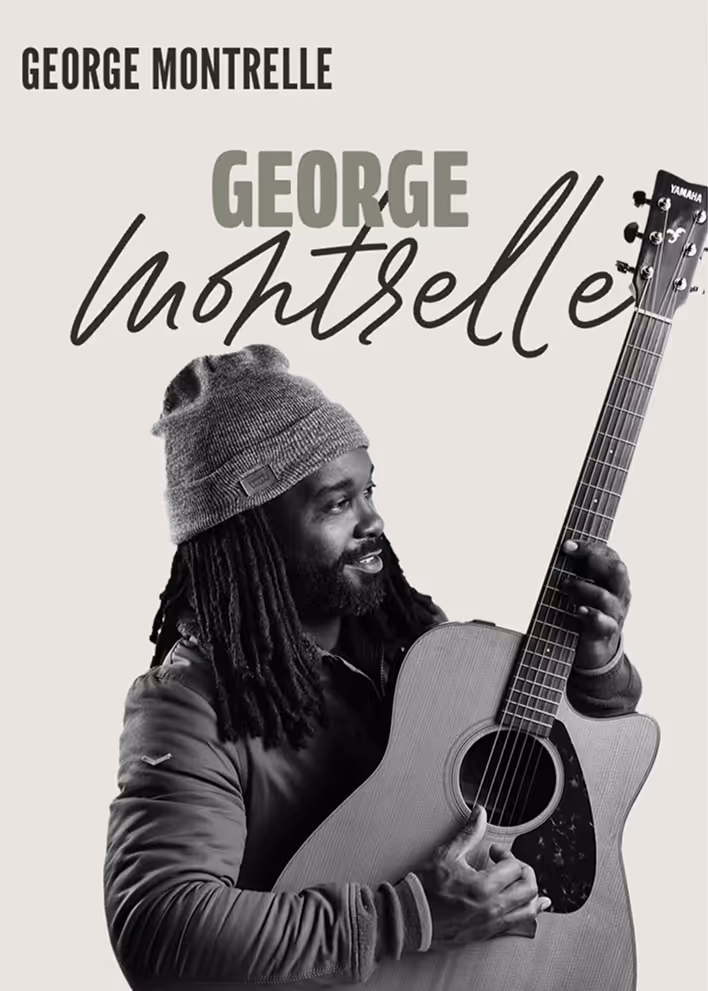 George Montrelle smiling and holding acoustic guitar in black and white