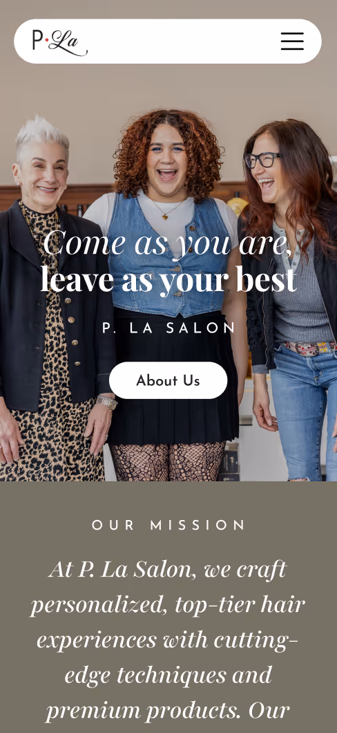 Three diverse women laughing together at P. La Salon