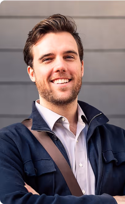 A man with a beard wearing a blue jacket.