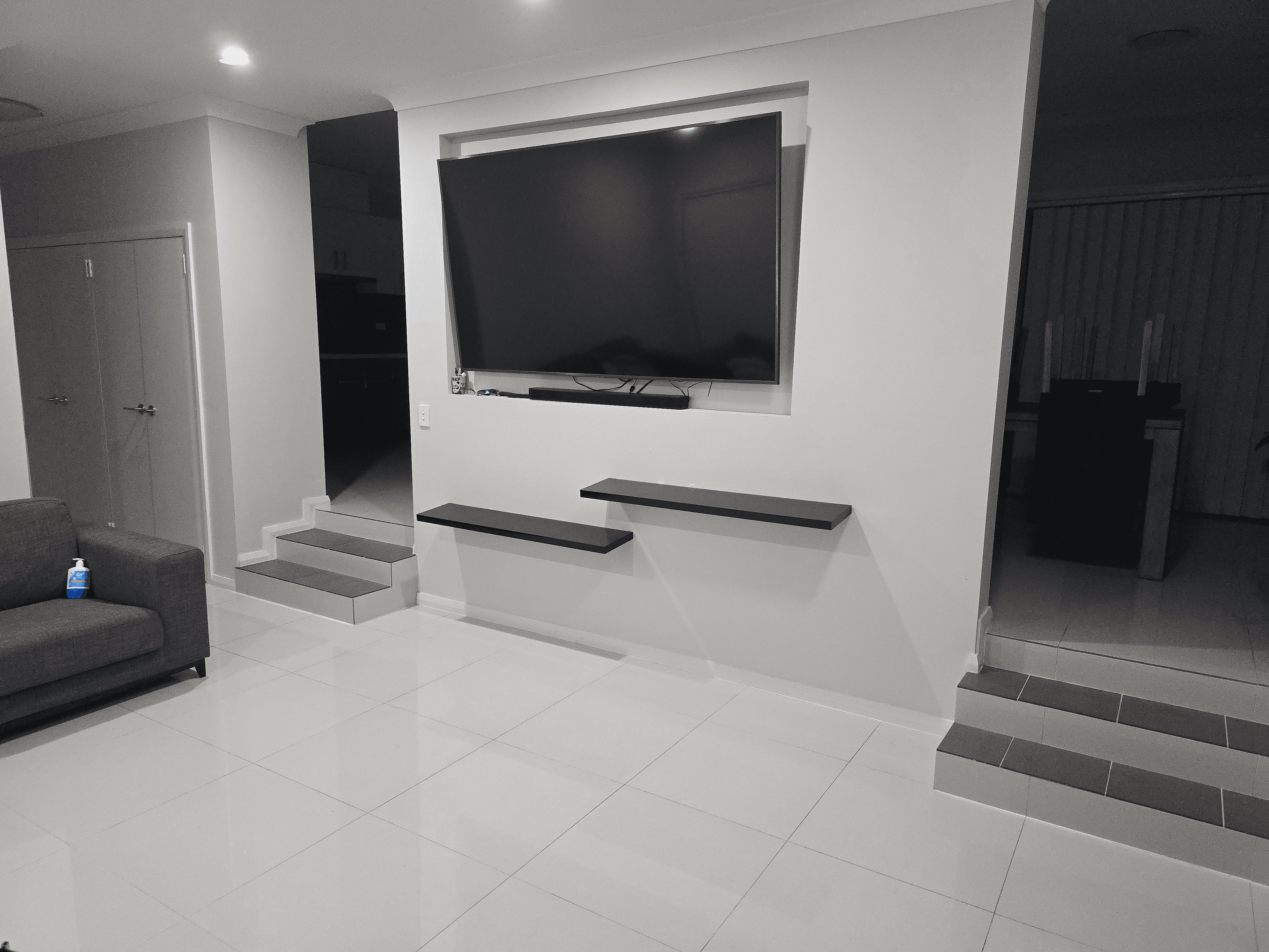 Professional living room clean Sydney - Spotless Interior Cleaning wipes TV & shelves. Baulkham Hill and Castle Hill.