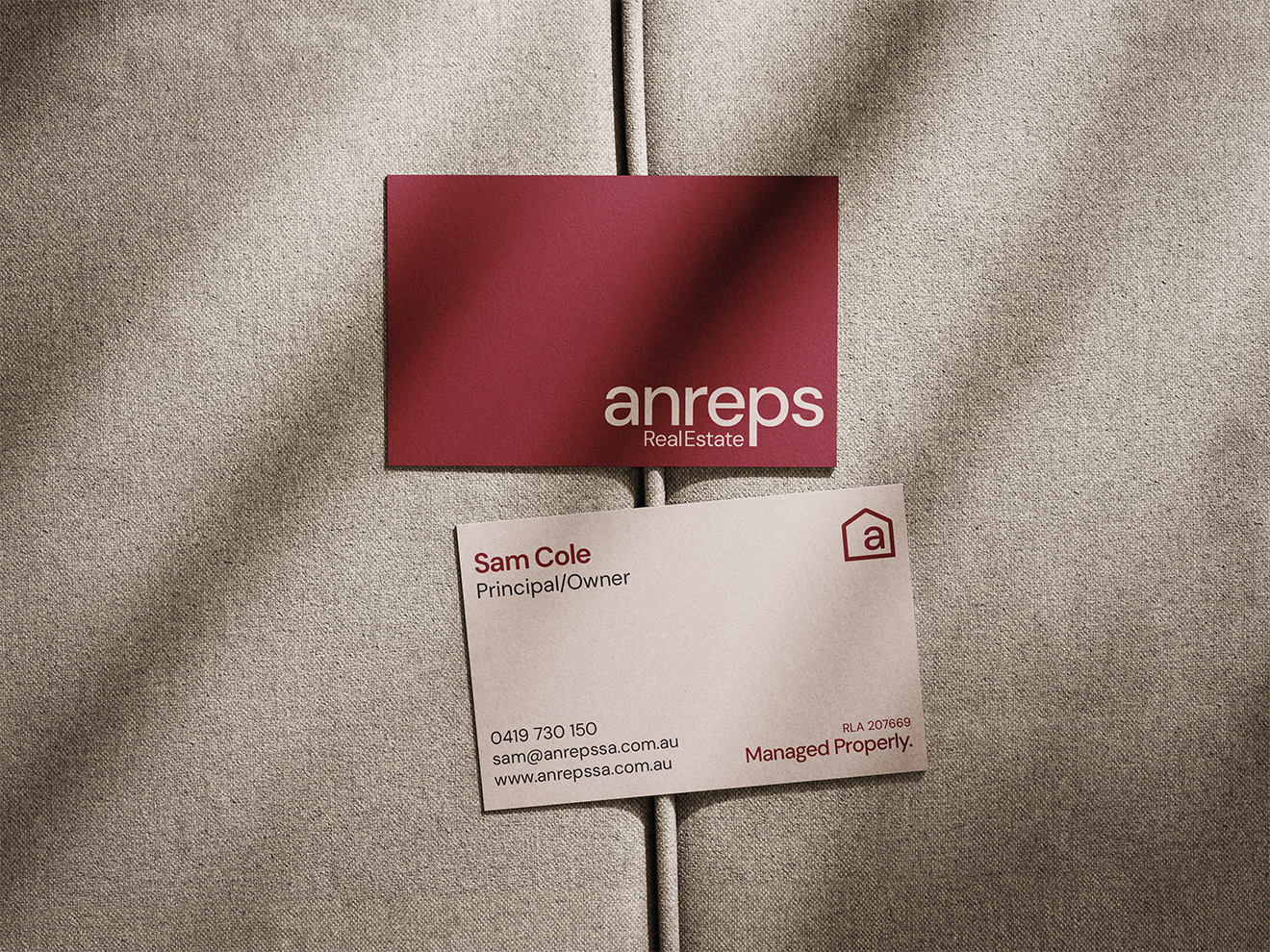 Anreps Real Estate business card for Sam Cole, Principal, featuring the refreshed logo and colour palette