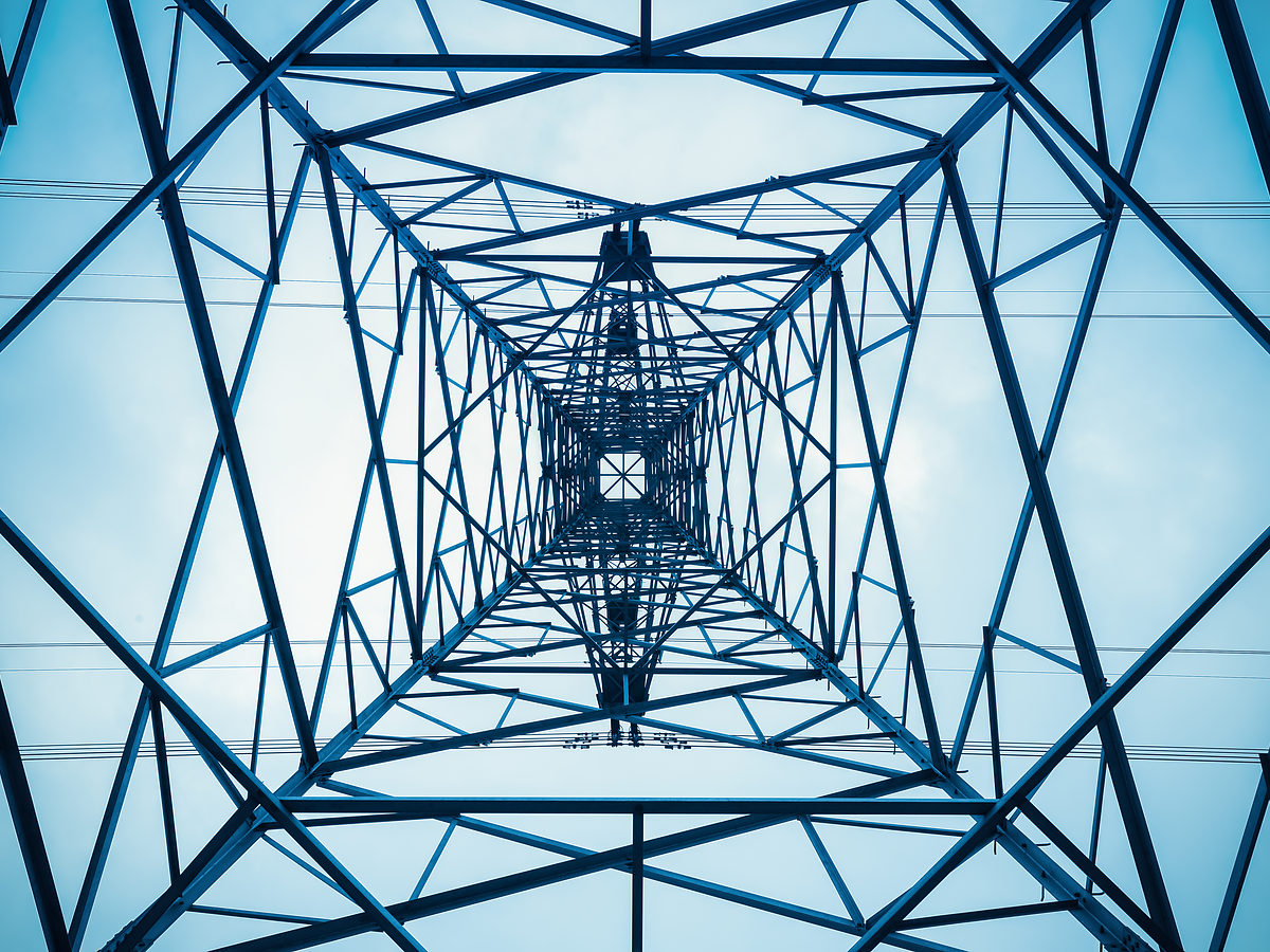 Transmission pylon seen from directly below, representing energy litigation investigations