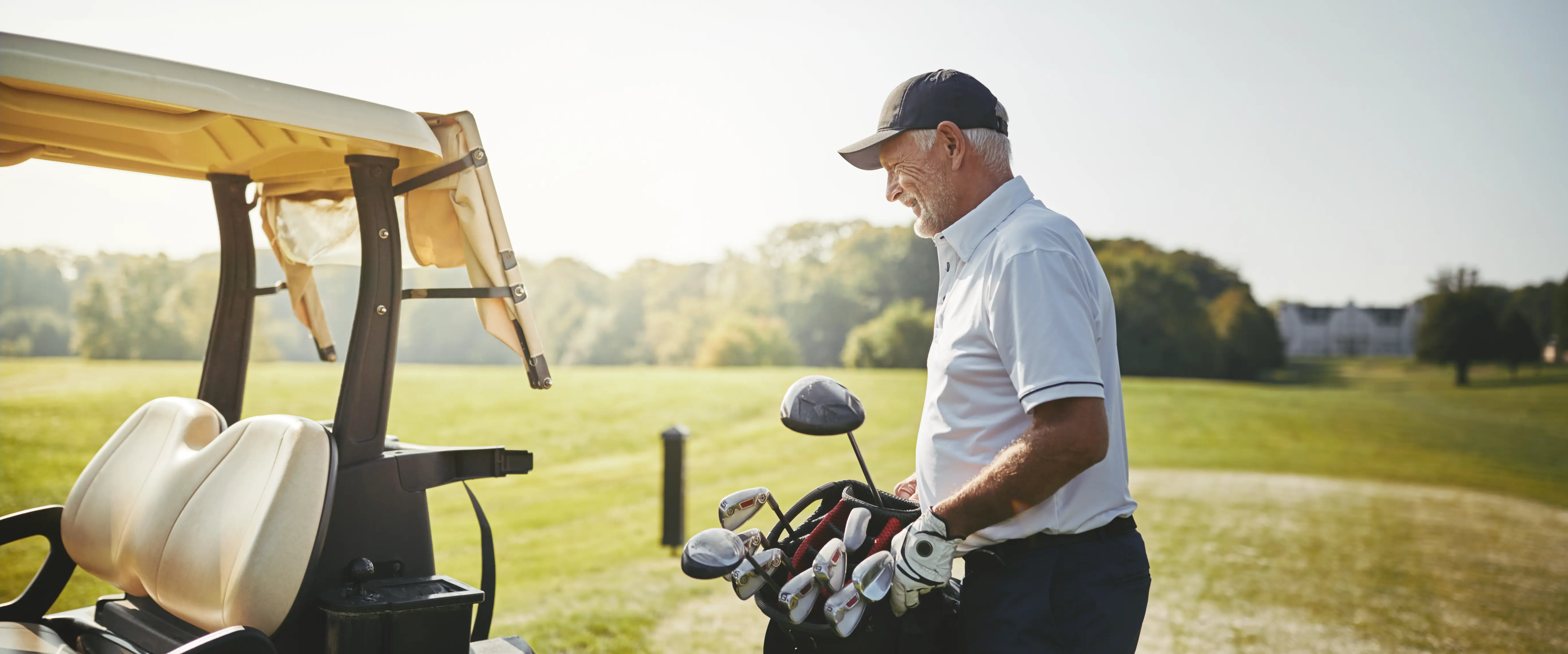 Senior golfer with golf clubs enjoying active lifestyle after successful shoulder surgery