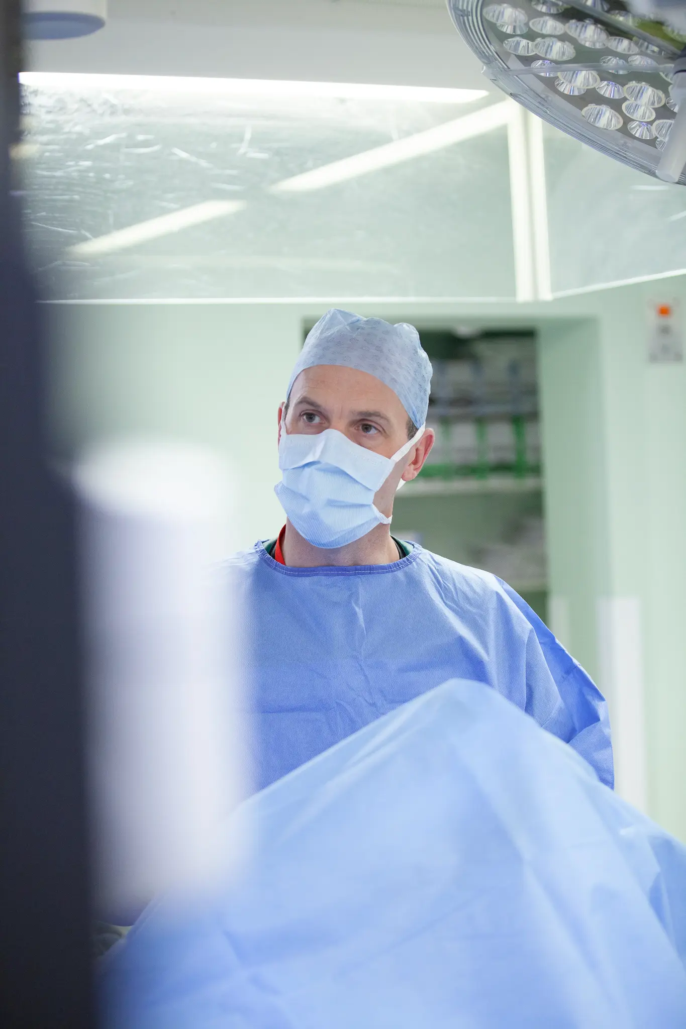 Shoulder surgeon in surgical scrubs preparing for orthopaedic procedure in operating room