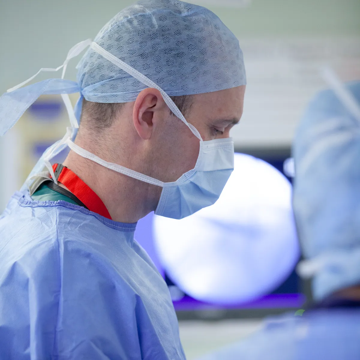 Mr Toby Baring operating, with a live X-ray screen in the background