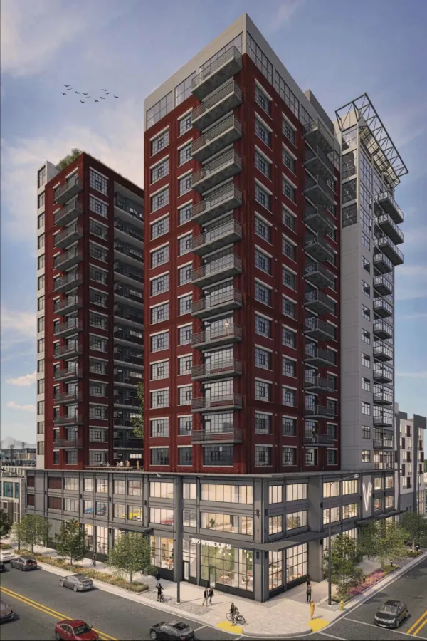 Modern multi-story residential building with red brick and large windows, balconies, street view with pedestrians and cars.