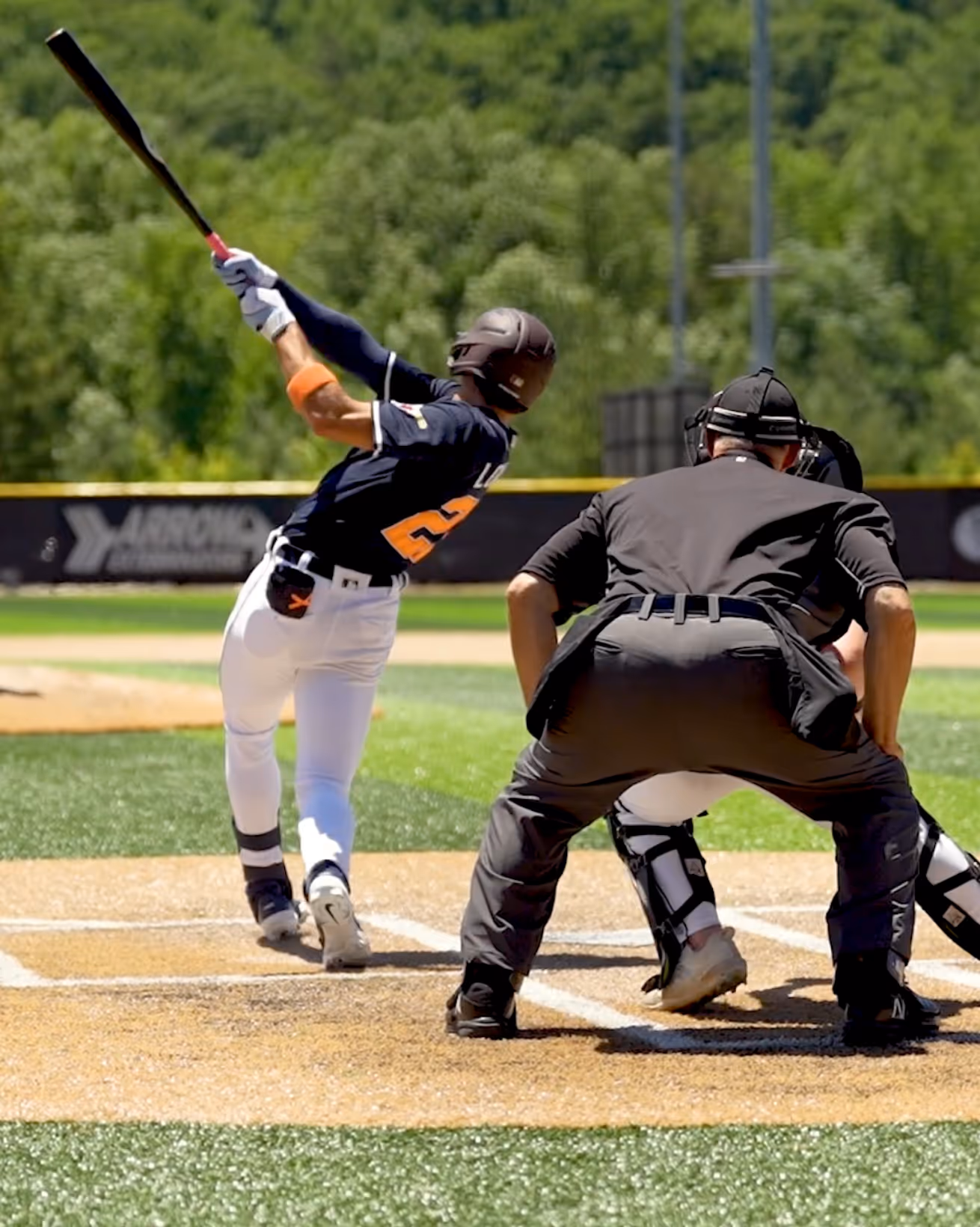 Baseball player following through swing