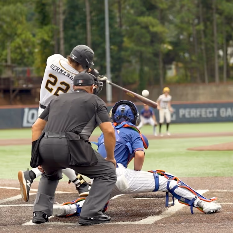 Baseball player making contact with baseball