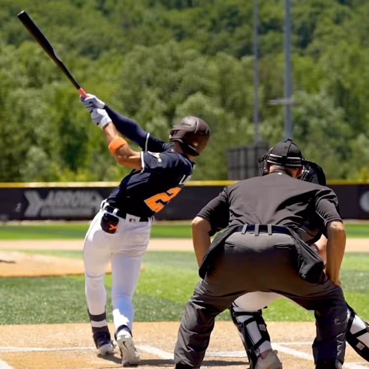 A baseball player following through on a swing