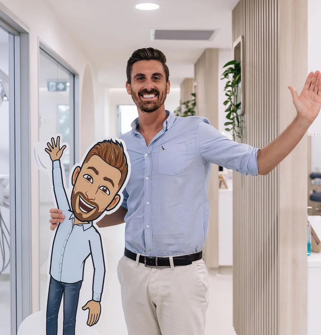 A man holding a cut out of a cartoon character.
