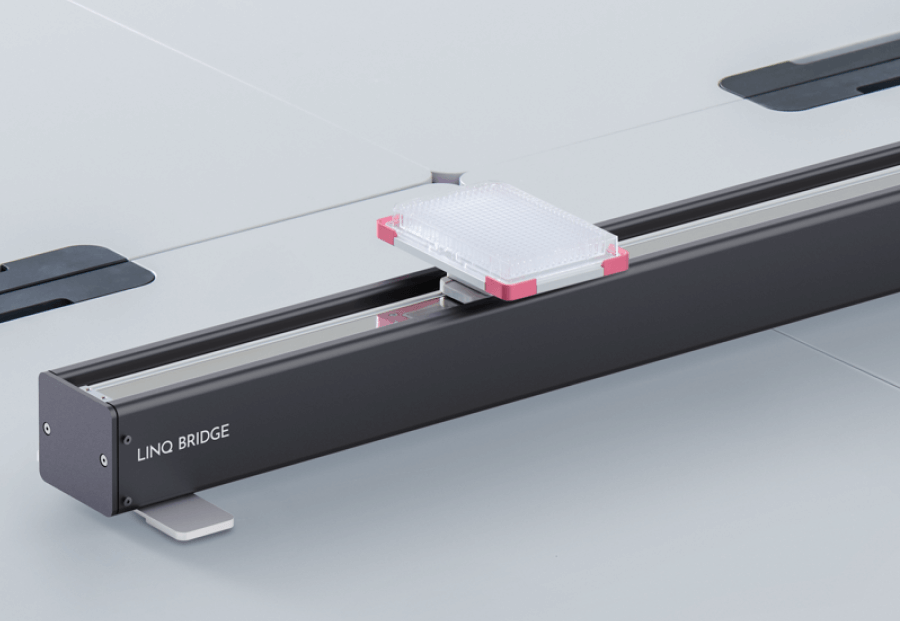 LINQ BRIDGE lab automation device holding a multi-well plate on a white surface.