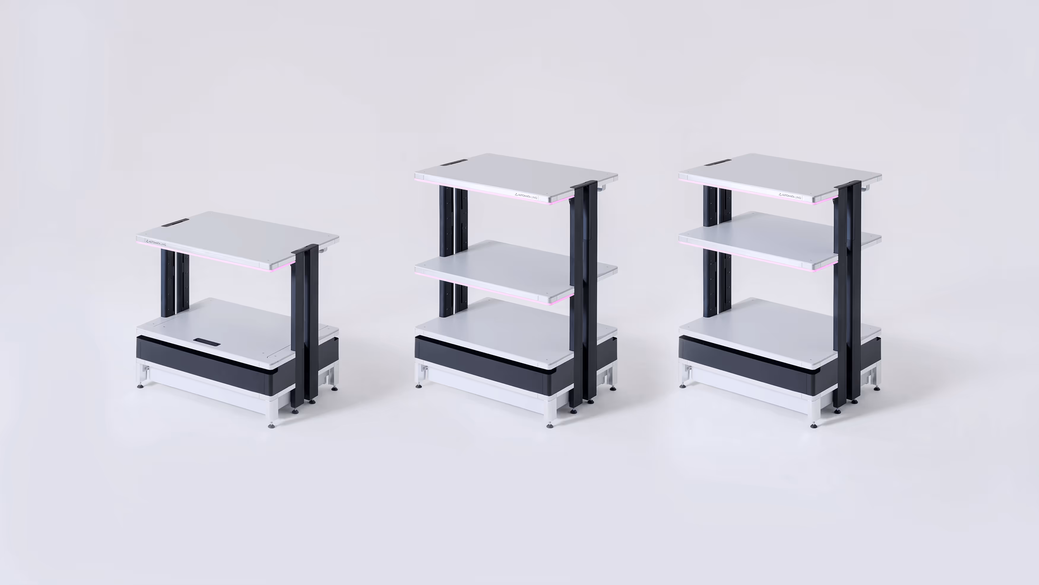 Three modular workbenches of varying heights with white shelves and black supports, arranged side by side on a white background.