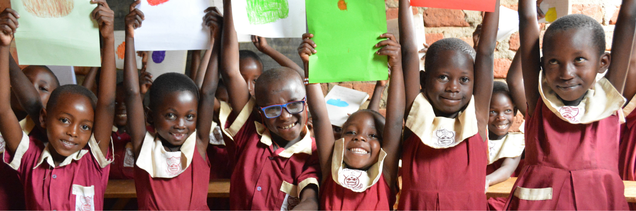 School children in Kilifi County holding up their work