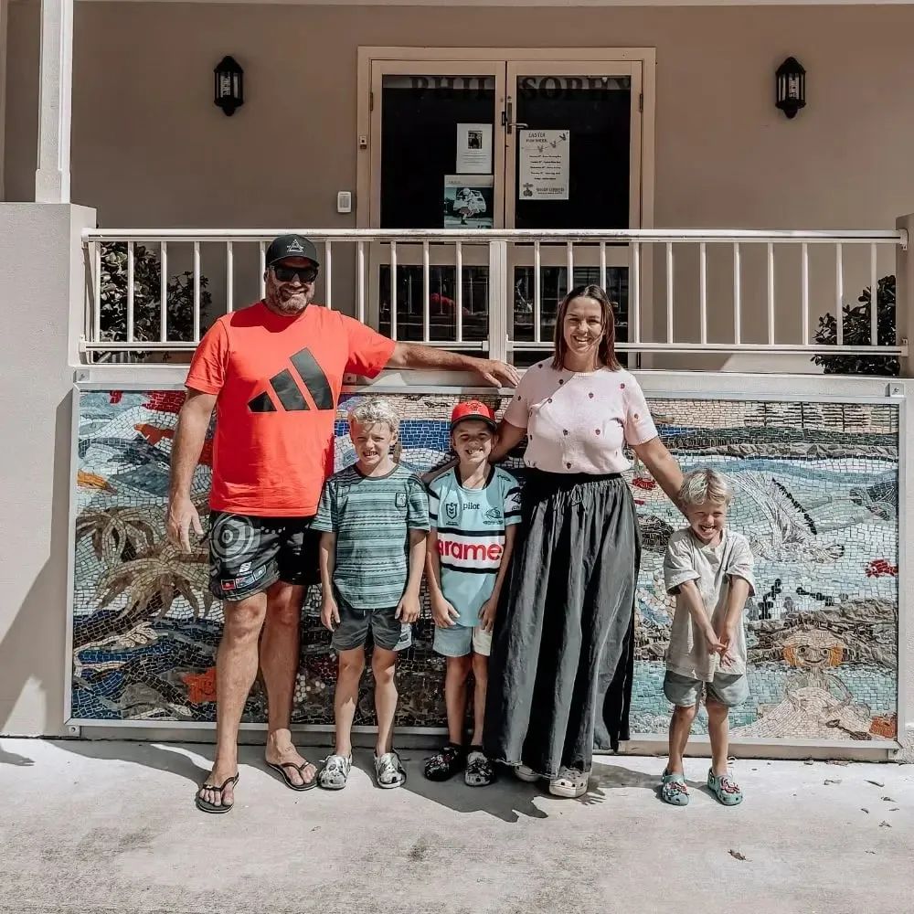 Family standing in front of a building.