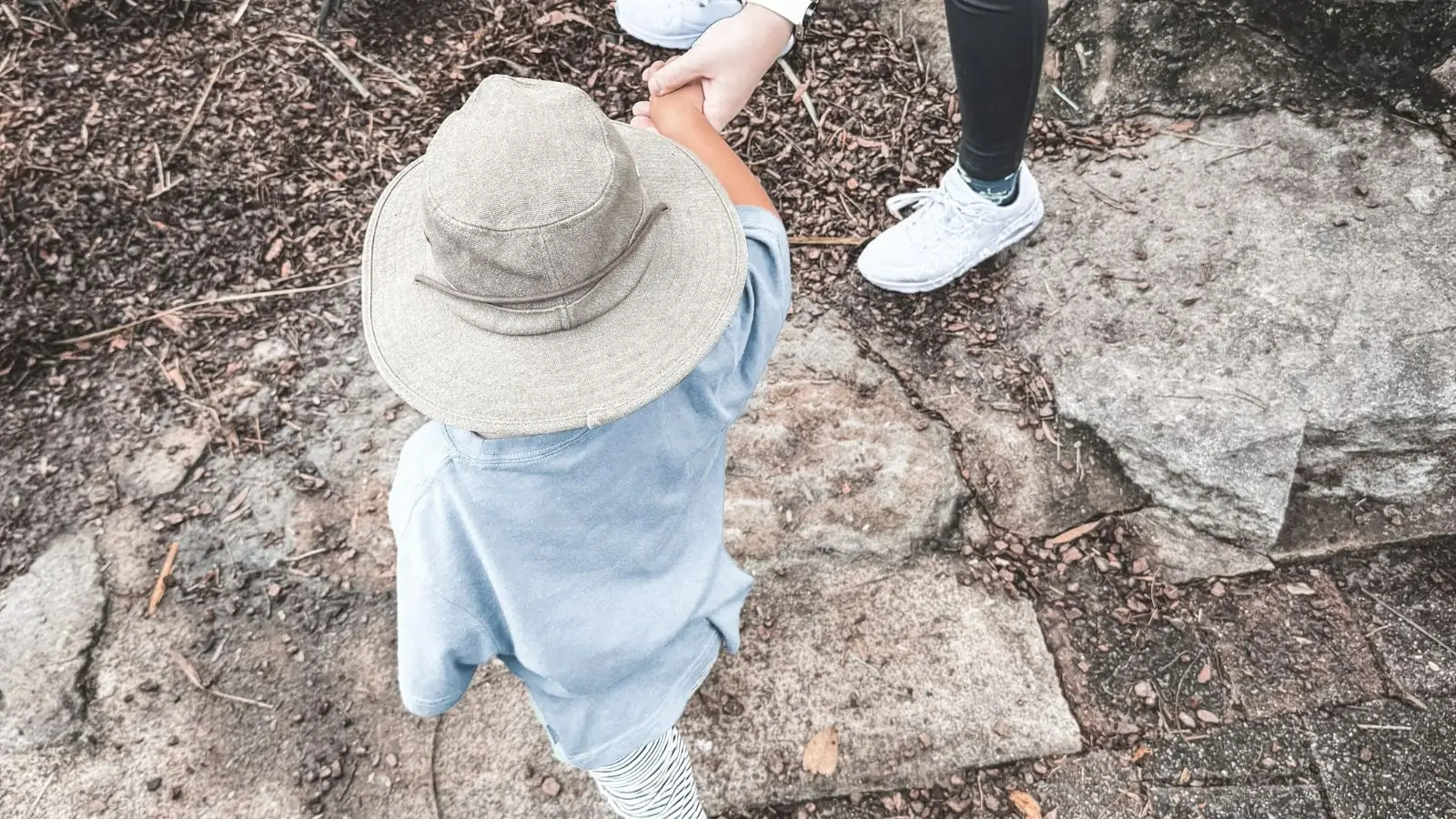 Two people standing next to each other holding hands.