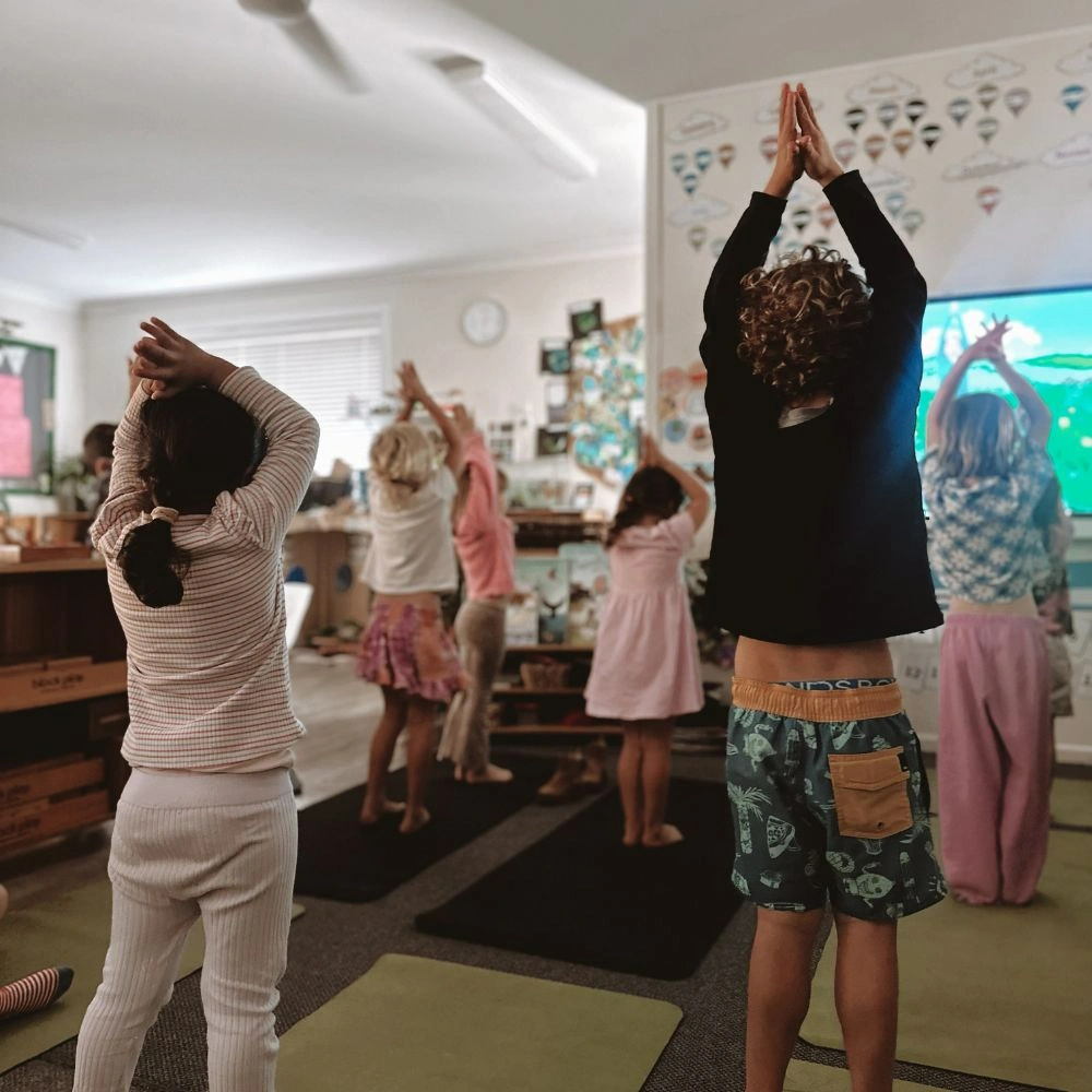 A group of people doing yoga in a room.