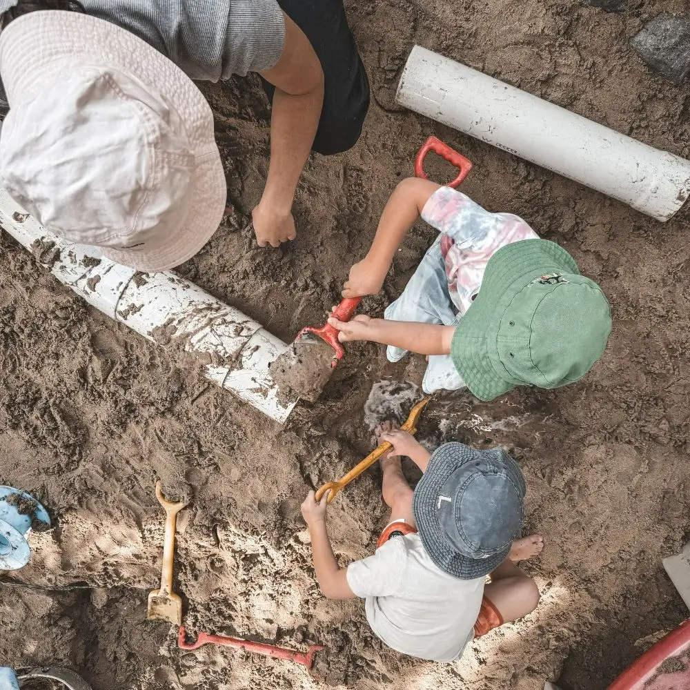 A group of children playing in the dirt.