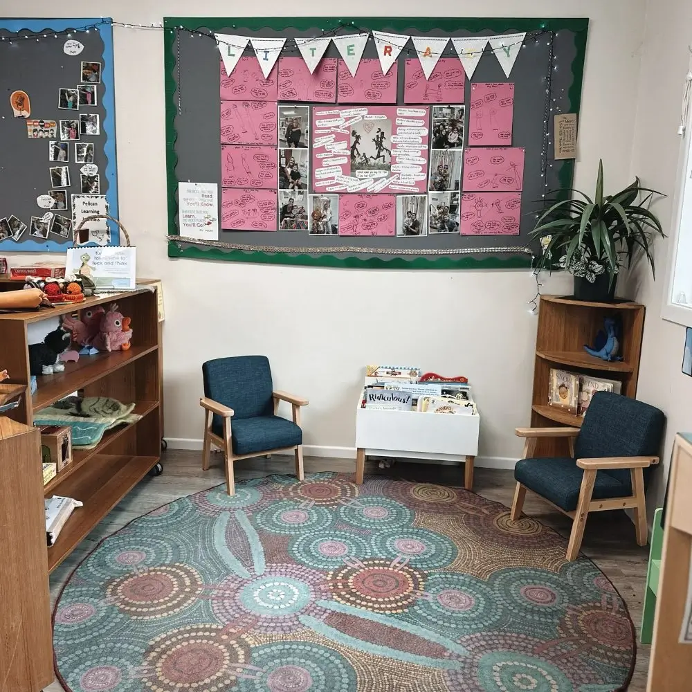 A child's room with a rug and chairs.