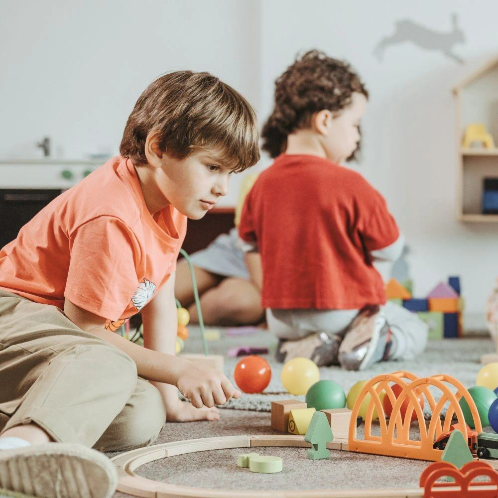 A group of children playing with toys in a room.