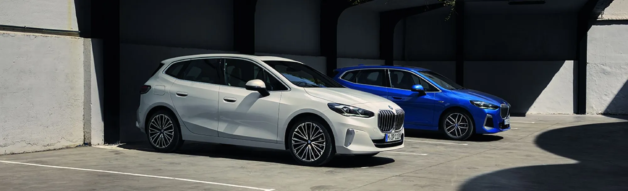 Two BMW cars parked together