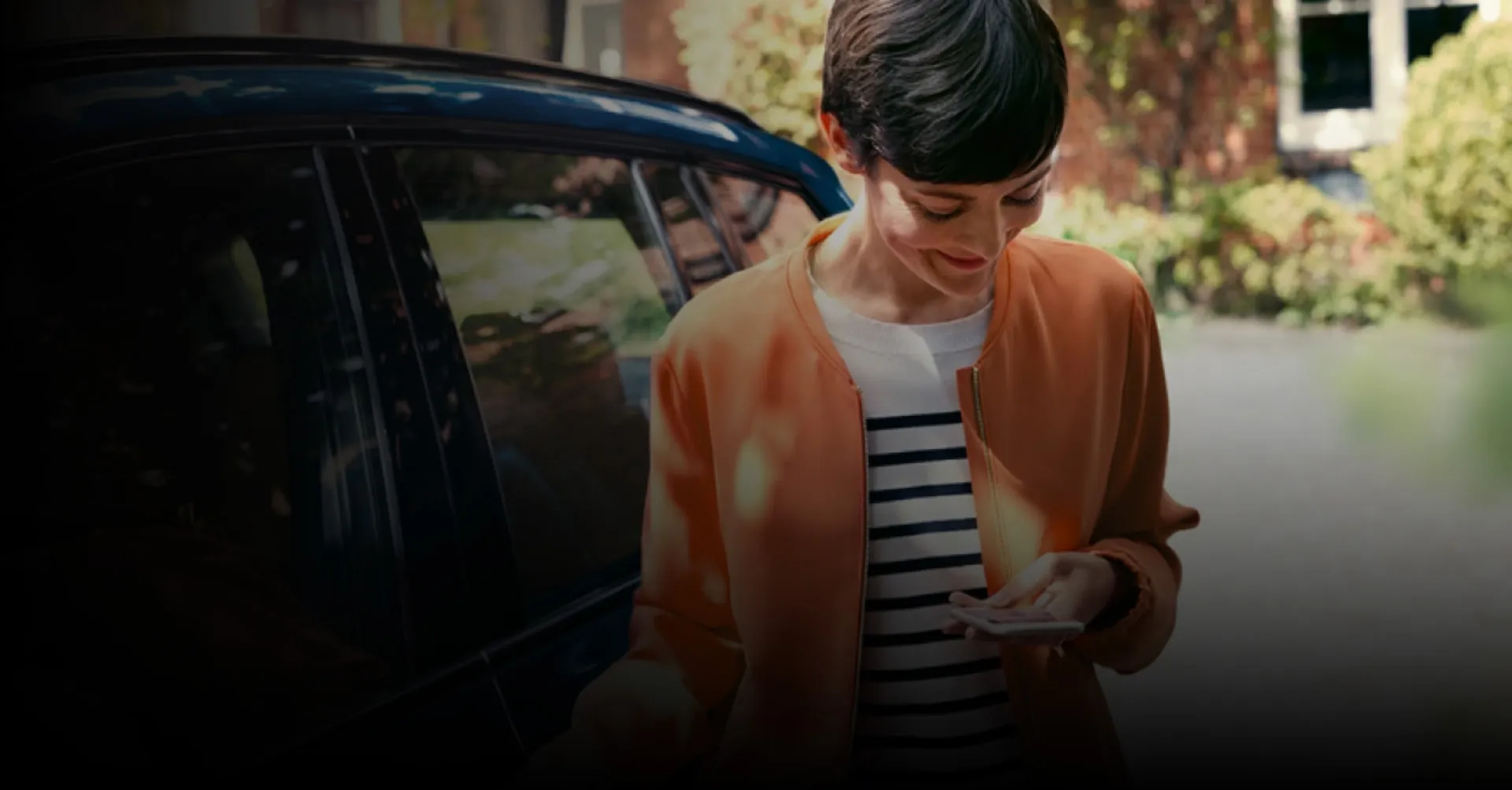 Person smiling while looking at their phone