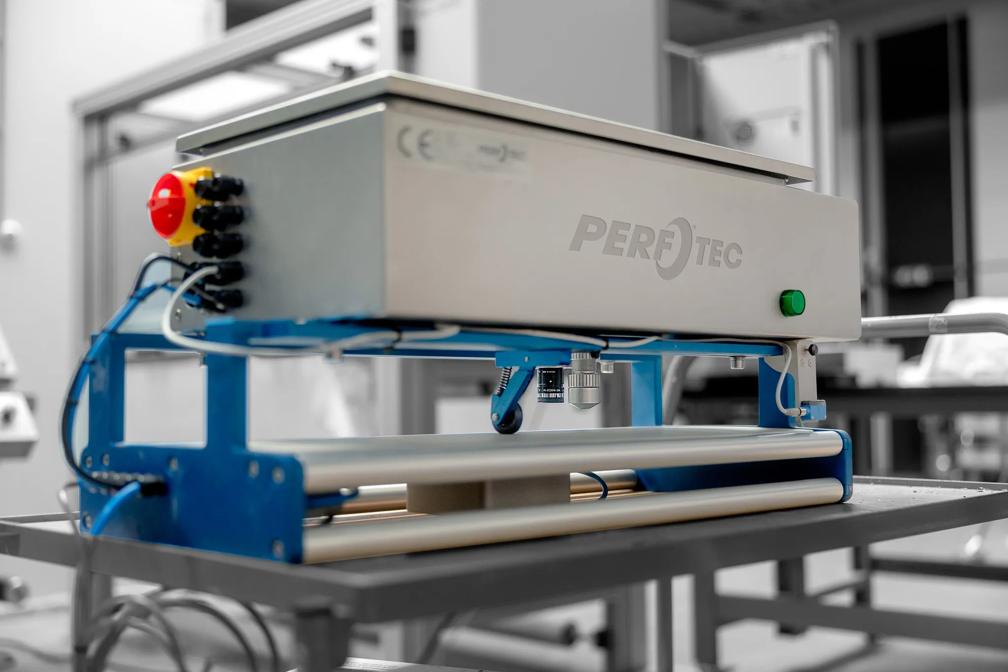 PerfoTec In-Line Laser System with laser head and inspection camera above the film rollers