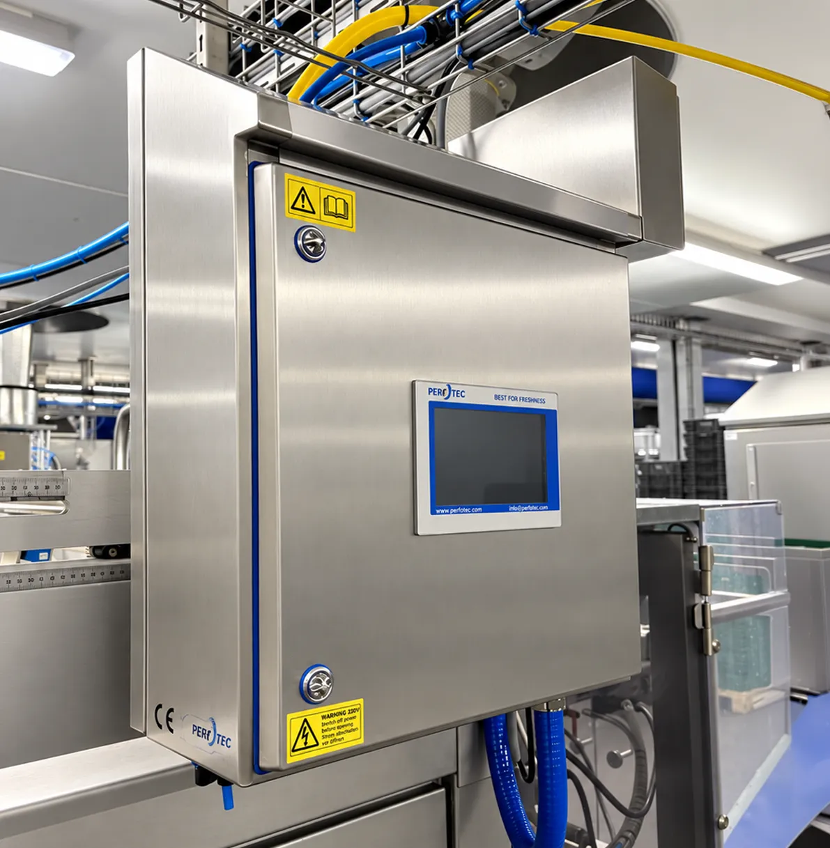 PerfoTec O₂Control gas flush cabinet with touchscreen, mounted on a fresh produce packing line