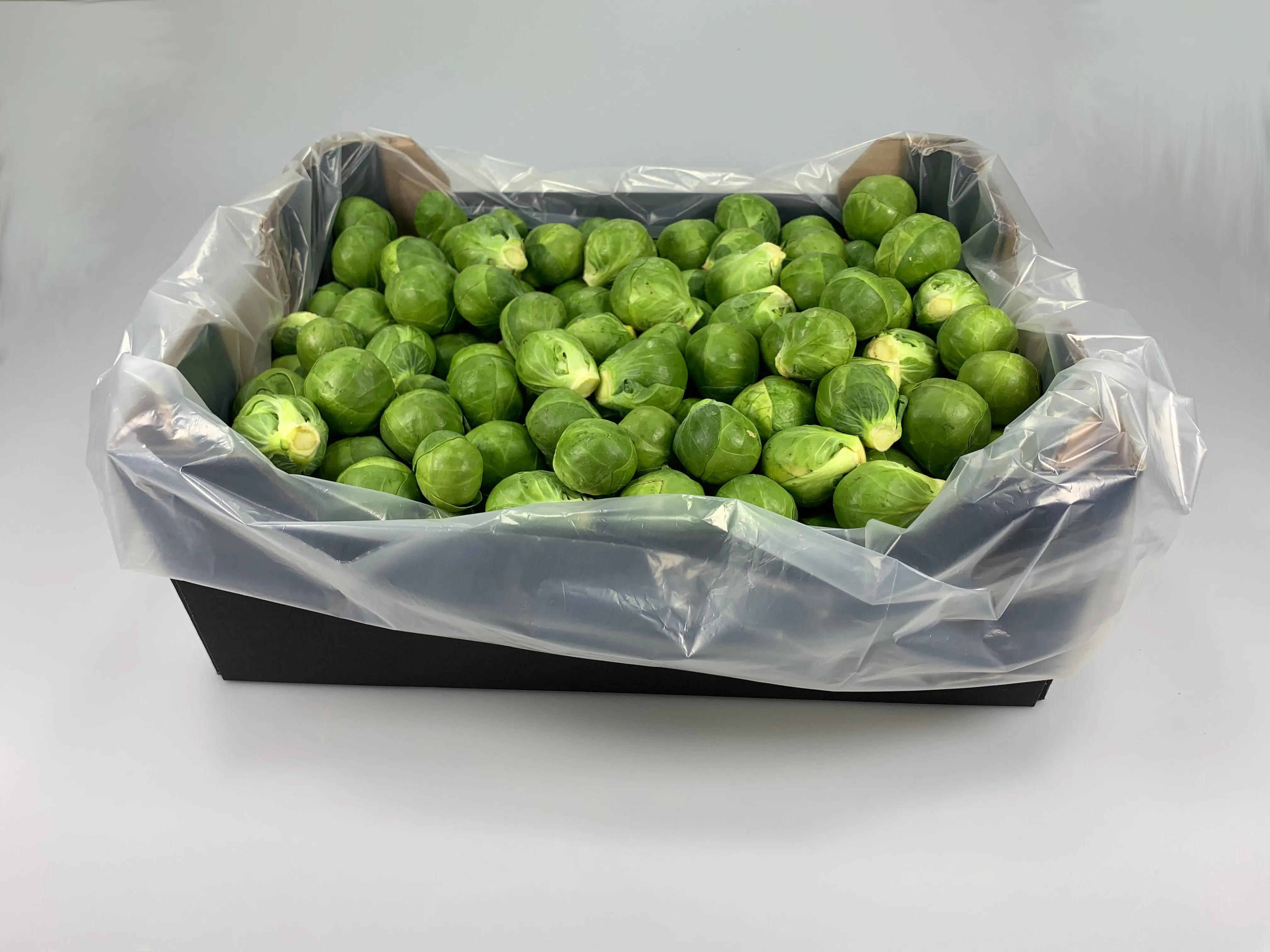 Box of Brussels sprouts packed in a PerfoTec compostable Liner