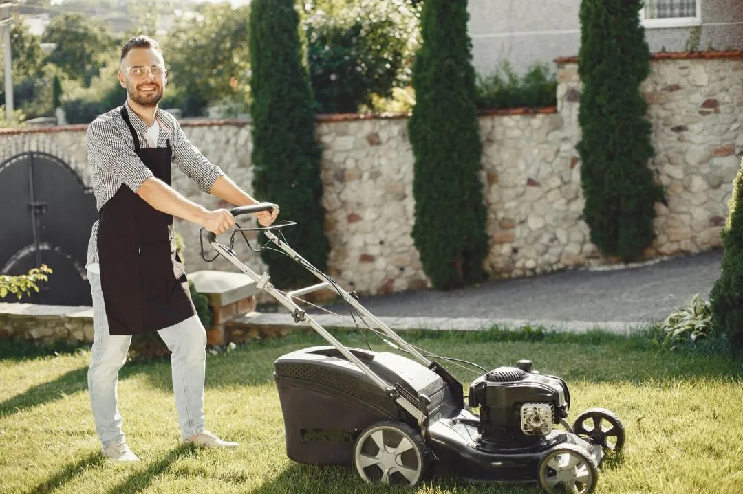 a man mows the lawn