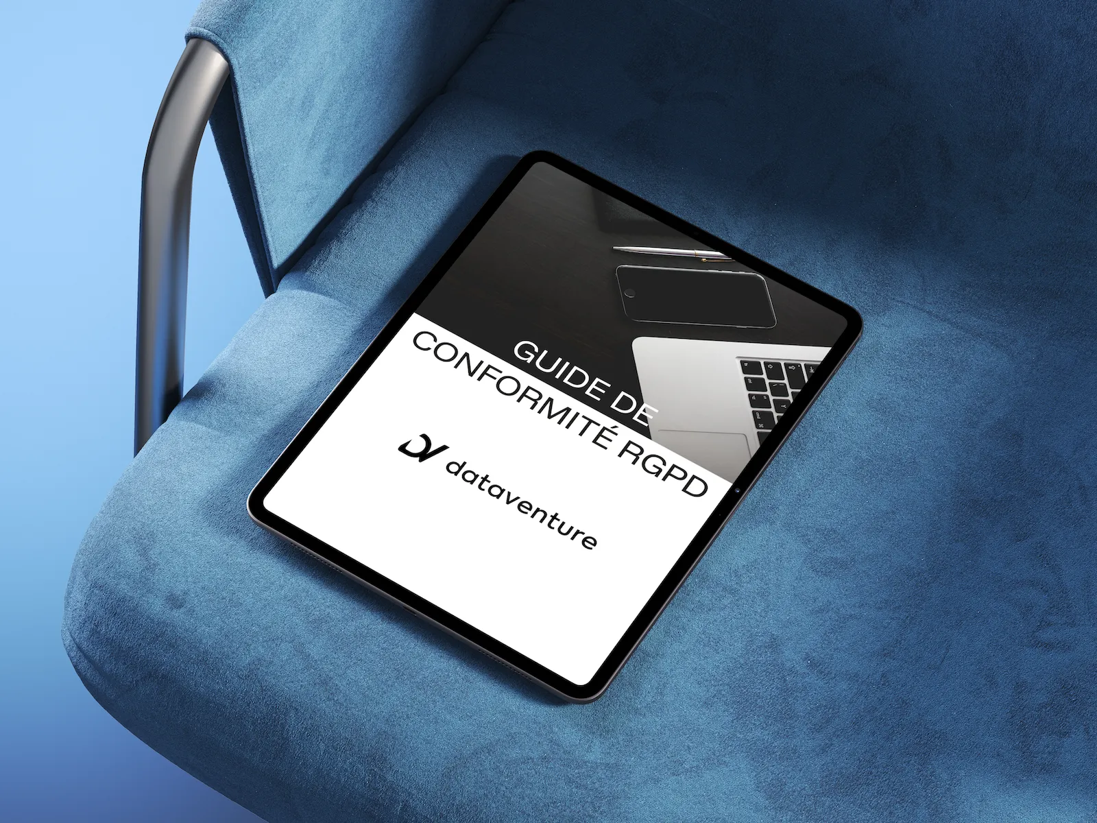 Tablet on a blue chair displaying a GDPR compliance guide with a laptop, phone, and pen in the background.