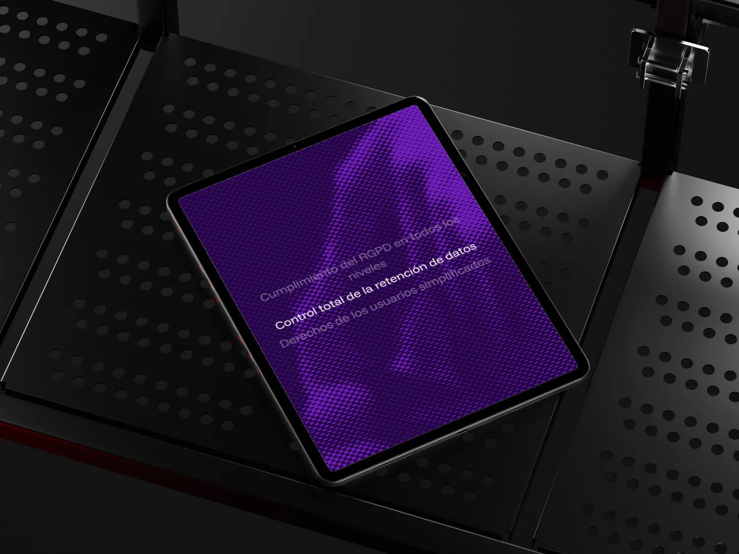 Tablet displaying purple screen with partially visible Spanish text about GDPR compliance and data retention control, placed on a black perforated metal surface.