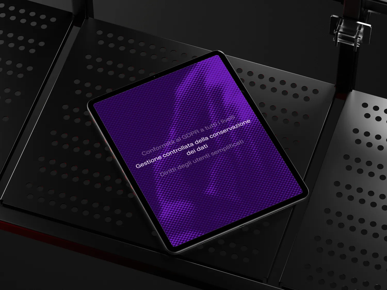 iPad Pro with a purple screen displaying Italian text about GDPR compliance and data management, placed on a black perforated metal surface.