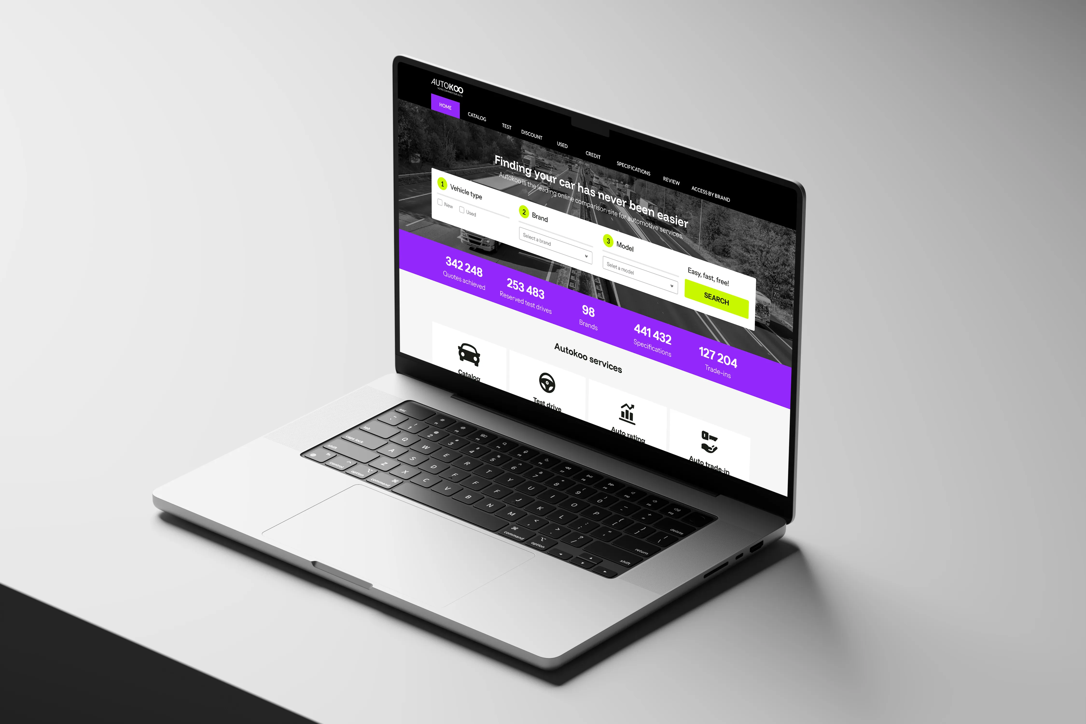 Open laptop displaying an online car comparison site with vehicle type, brand, and model selection forms and statistics on quotes, test drives, brands, specifications, and trade-ins.