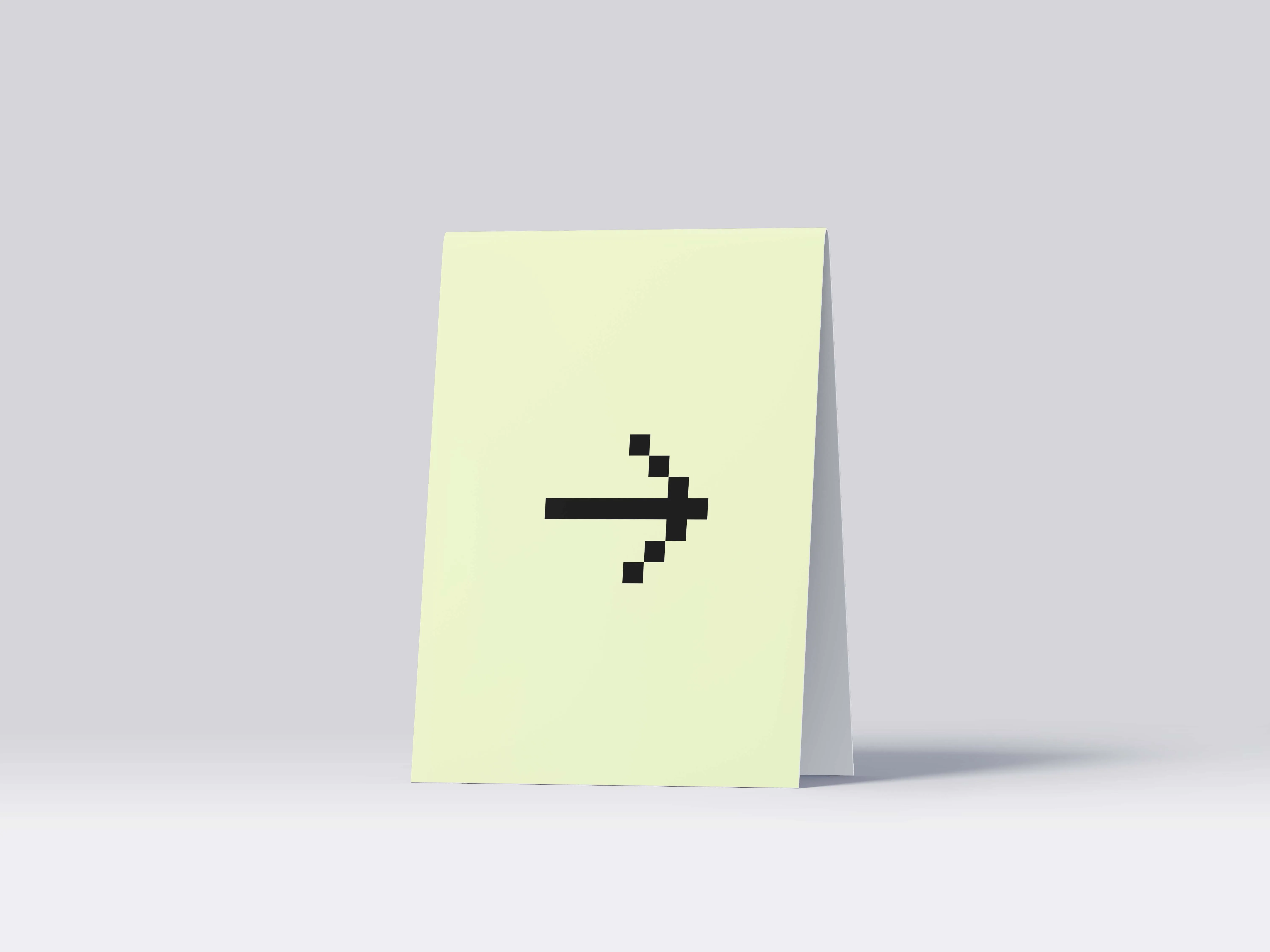 Folded white card standing on a surface with a pixelated black right arrow in the center.