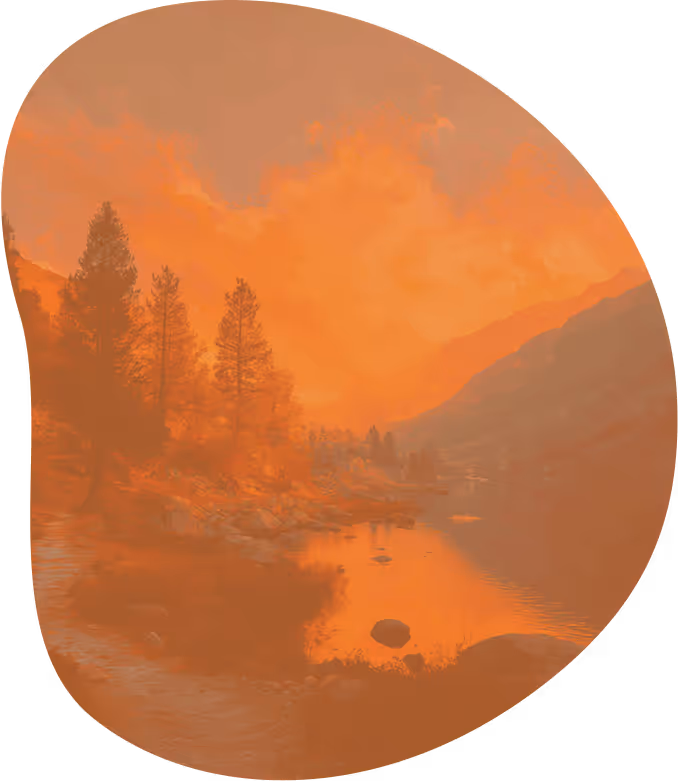 a river with trees and mountains in the background