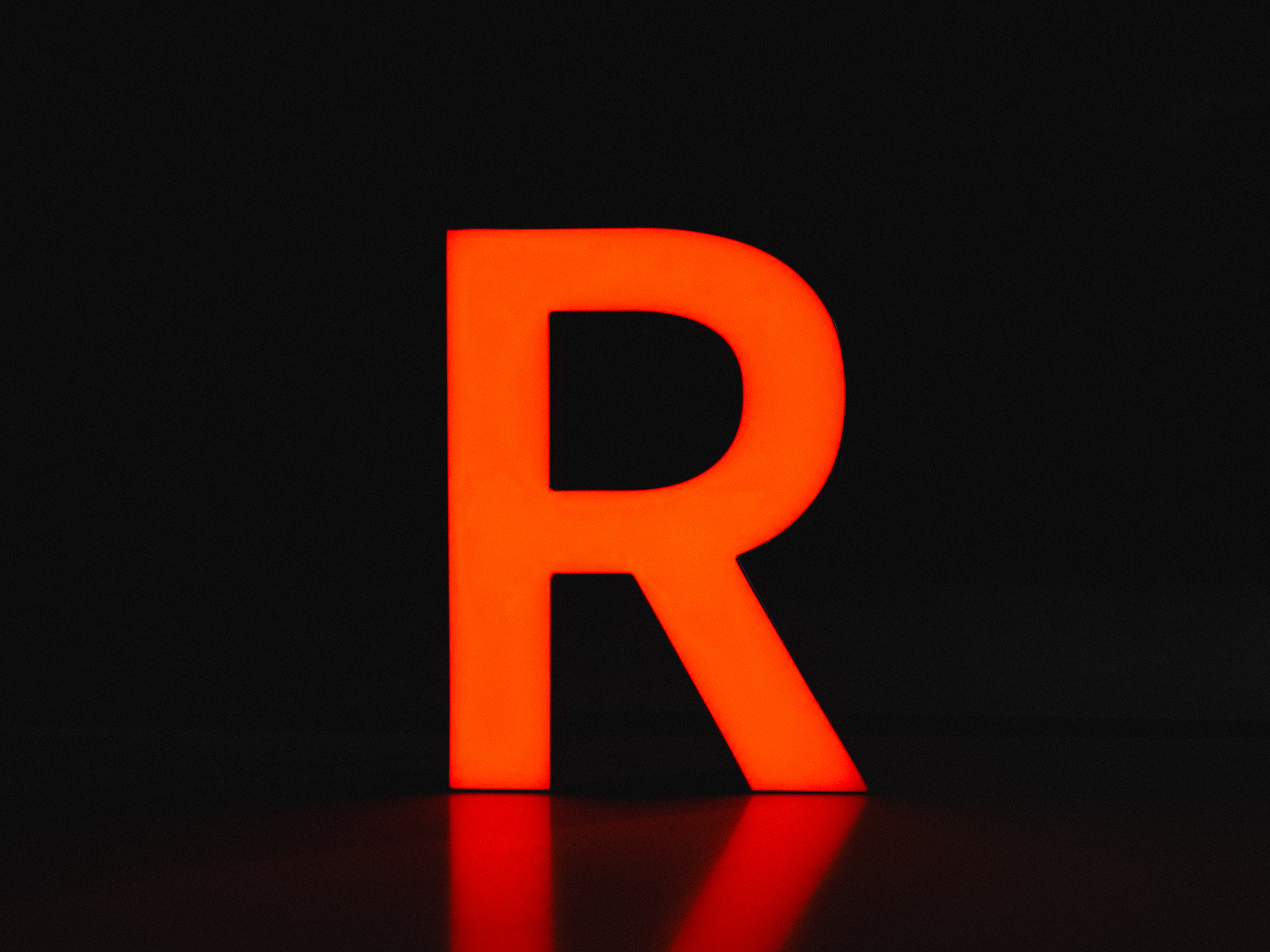 UF1 unibody trimless face-lit channel letter with white acrylic face and orange LED illumination.