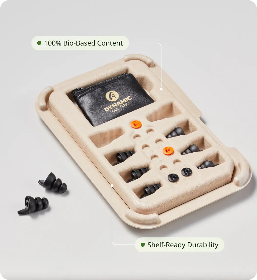 Sustainable molded fiber packaging tray made from 100% bio-based material, holding Dynamic ear filters and a small black carrying pouch.