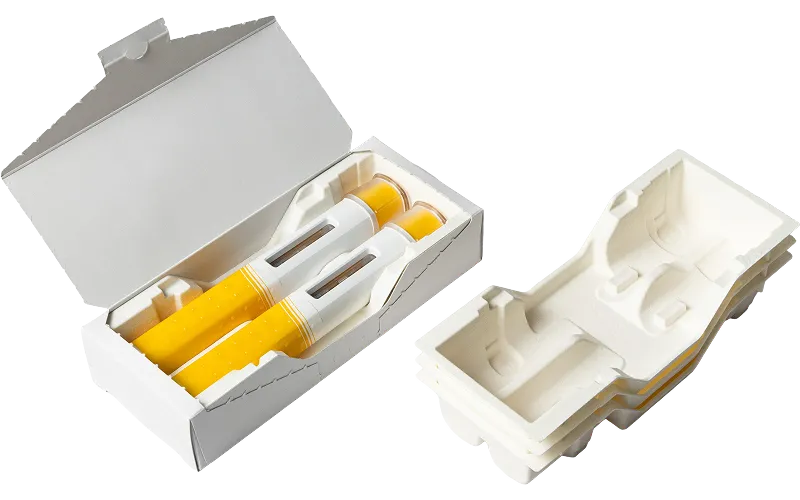 Sustainable molded fiber packaging trays inside a paper box for cylindrical products, eco-friendly and recyclable design by Nissha.