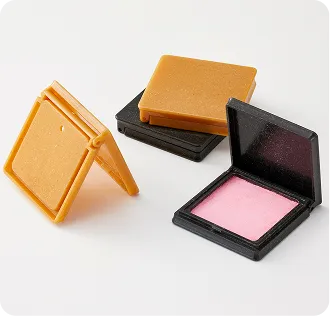 Eco-friendly square cosmetic compacts made from biodegradable materials, featuring sustainable packaging design for makeup products.