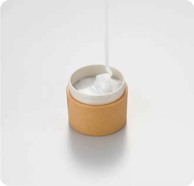 Eco-friendly cosmetic jar made from sustainable molded material, filled with white cream, showcasing biodegradable packaging design for skincare products.