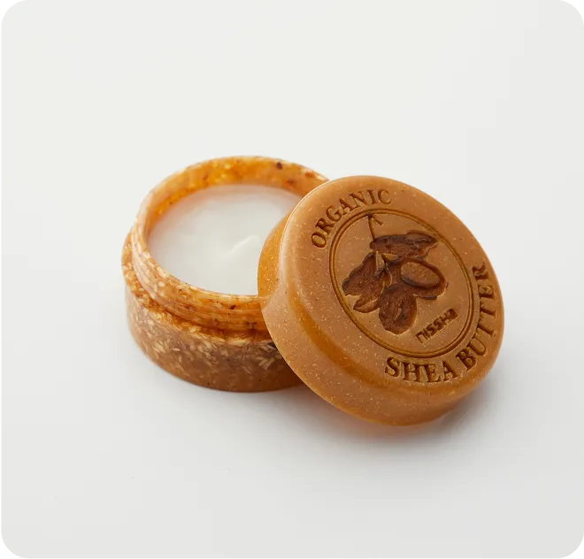 Organic shea butter jar with embossed eco-friendly lid made from biodegradable material, showcasing sustainable skincare packaging design.