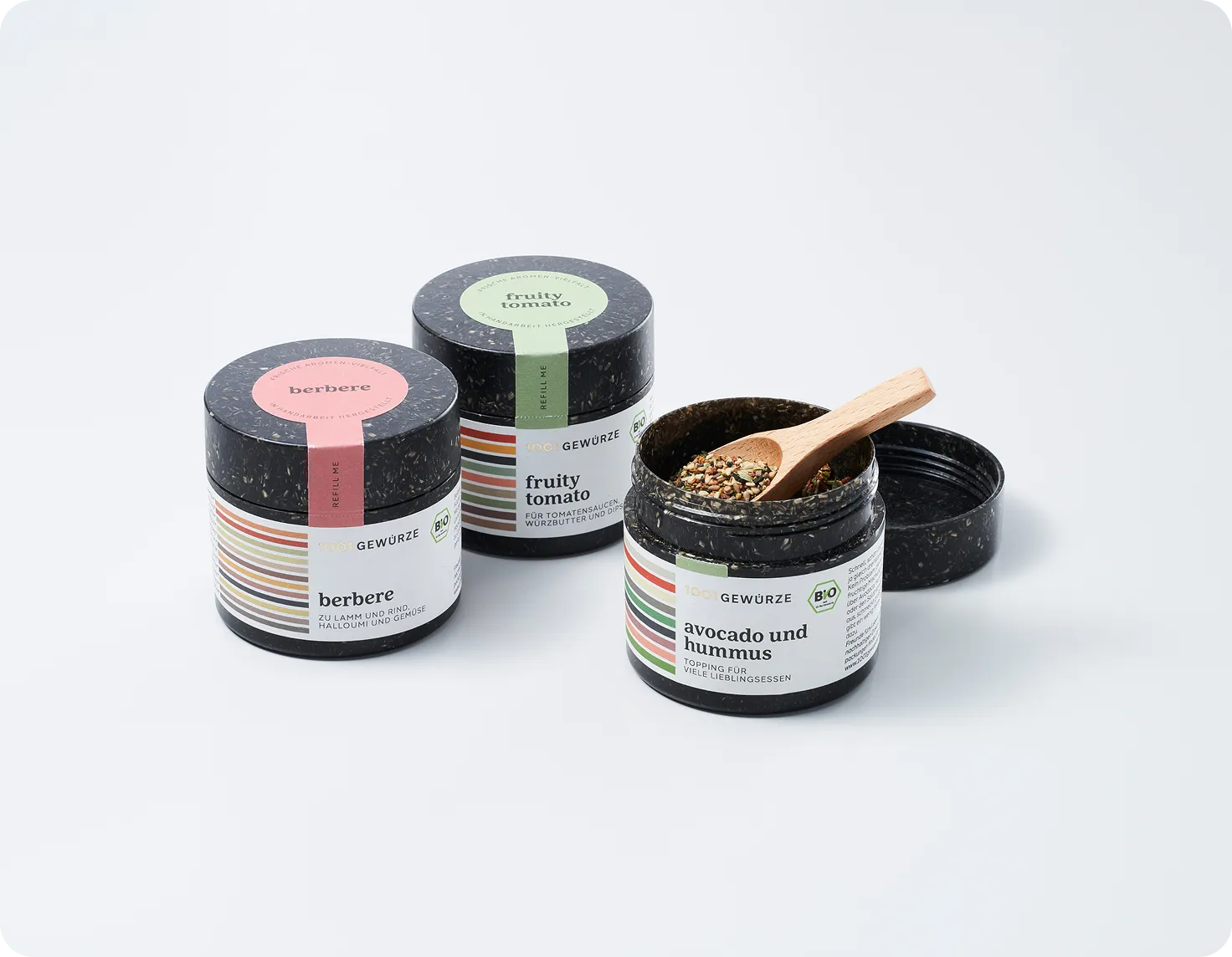 Eco-friendly spice jars made from sustainable materials featuring organic seasonings berbere, fruity tomato, and avocado und hummus by 1001 Gewürze.
