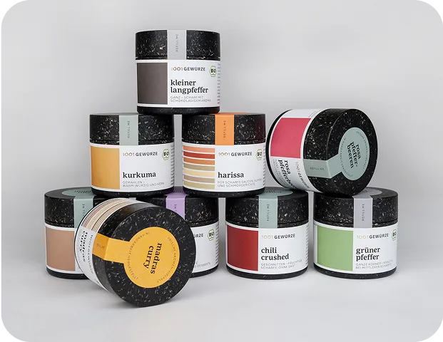Collection of 1001 Gewürze organic spice jars with eco-friendly black packaging and colorful labels, showcasing sustainable and modern design for premium spices.