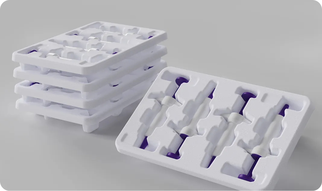 Stack of eco-friendly molded pulp trays for industrial or medical packaging, showcasing sustainable, shock-absorbent, and stackable protective design.