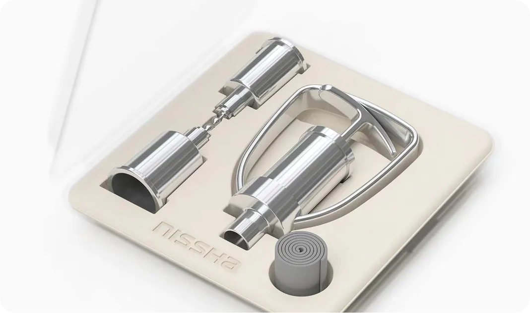 Sustainable molded pulp packaging tray with precision metallic components by Nissha, showcasing eco-friendly industrial packaging design and premium presentation.