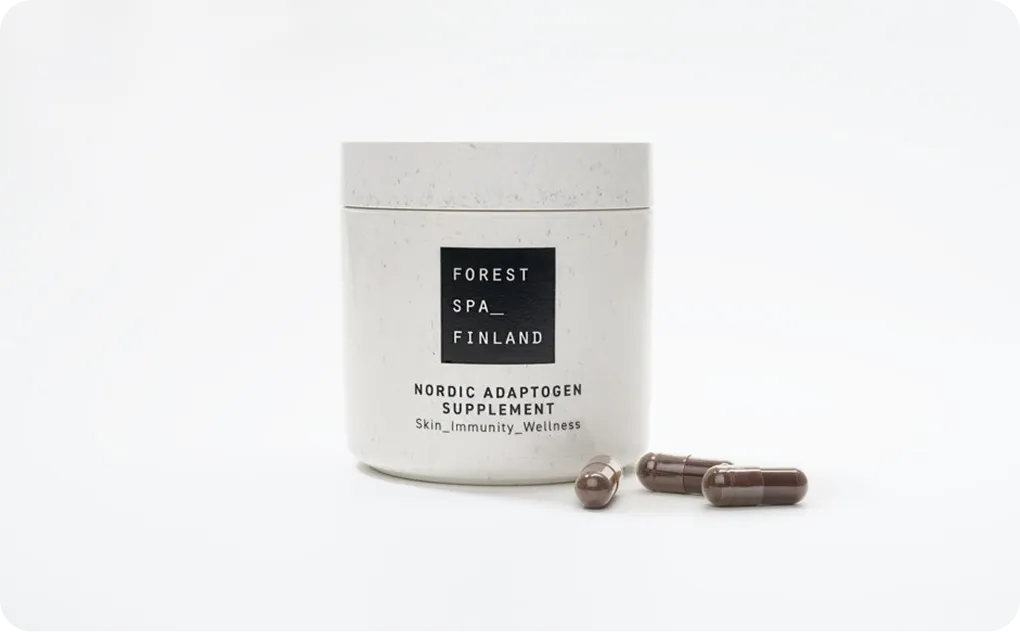 Forest Spa Finland Nordic Adaptogen Supplement in eco-friendly white jar with brown capsules on white background, representing sustainable wellness packaging.