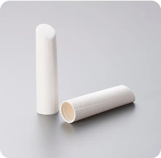 Eco-friendly molded fiber tubes on gray surface, showcasing sustainable paper-based packaging components for medical or cosmetic applications.