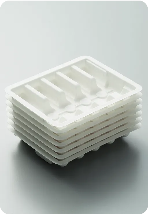 Stack of white biodegradable molded fiber trays with compartments, showcasing sustainable and eco-friendly packaging design.